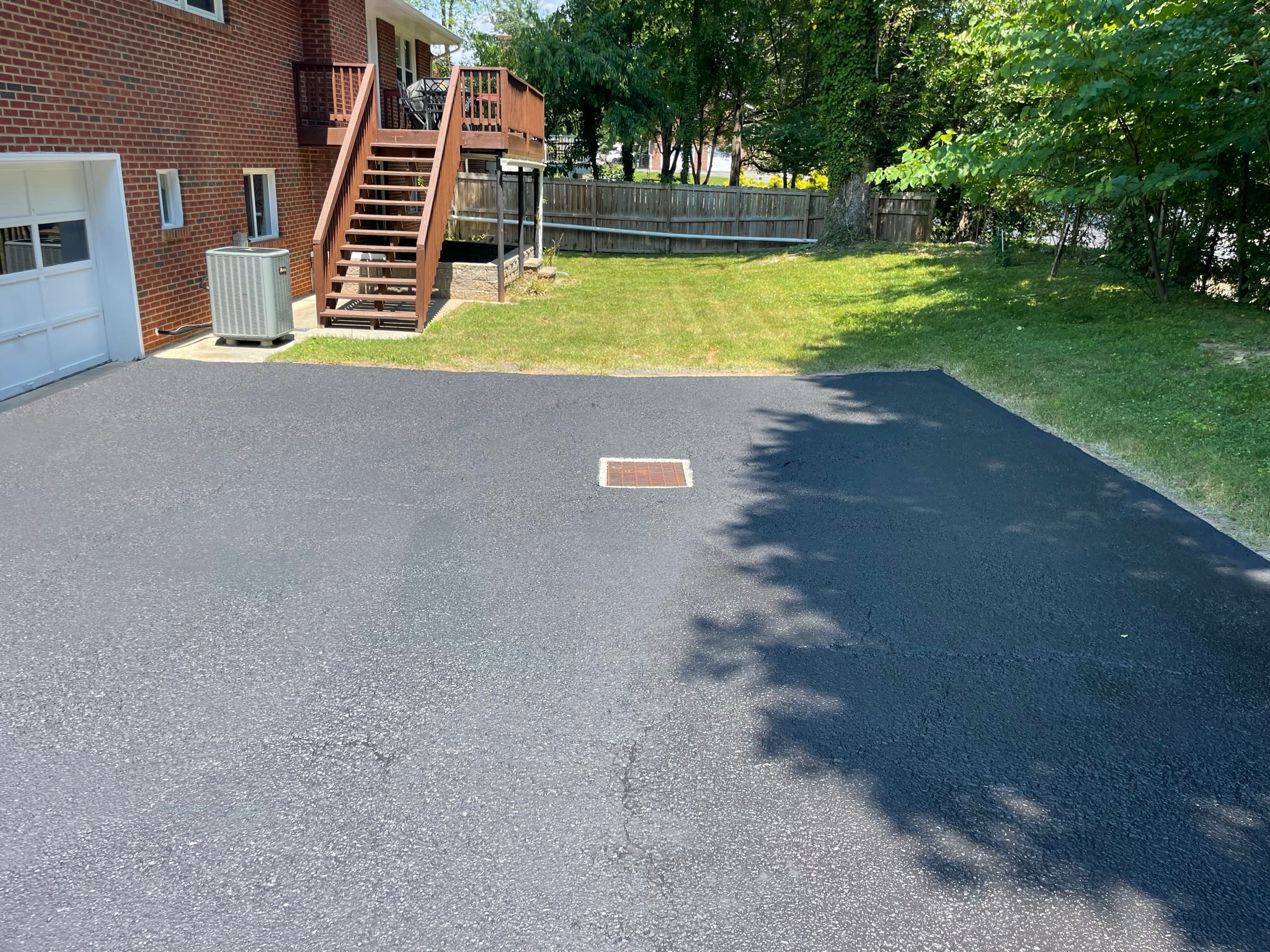 Fresh sealcoated driveway by Grit to Gloss Softwash Pros
