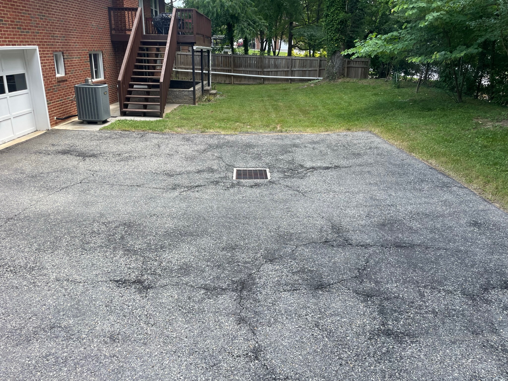 Faded asphalt driveway before sealcoating in Central Virginia