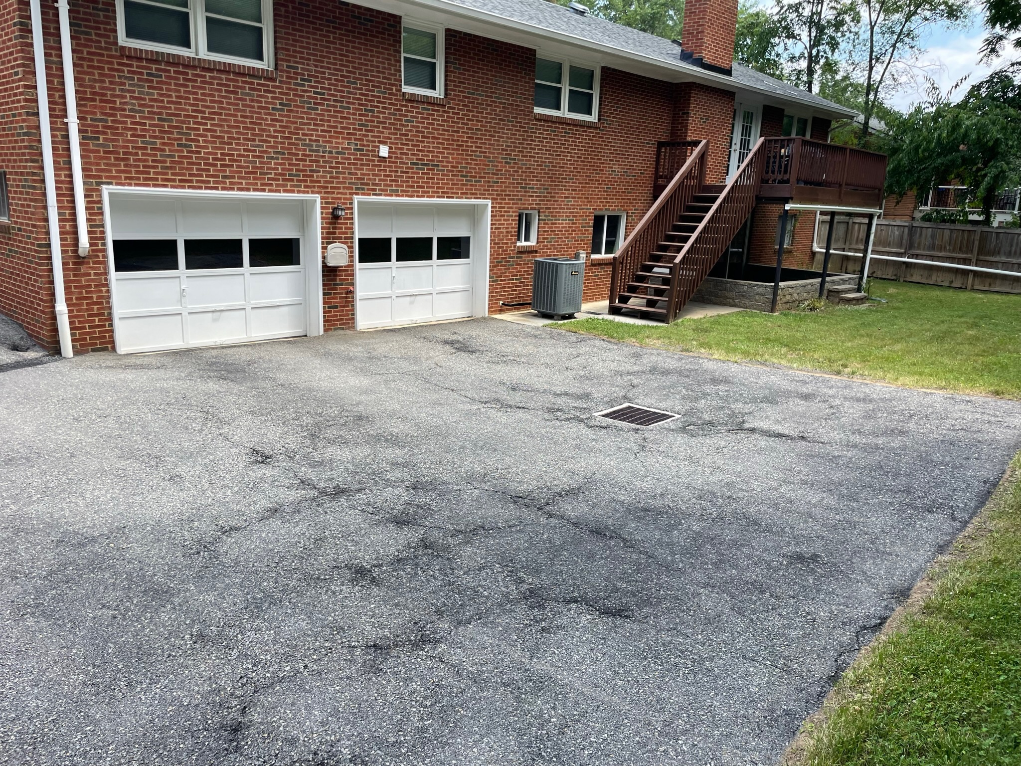 Worn asphalt surface before sealcoating